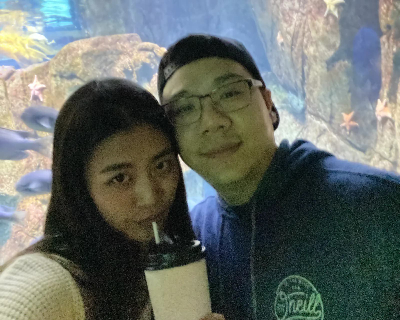 Christine and Thomas taking a selfie in front of an aquarium