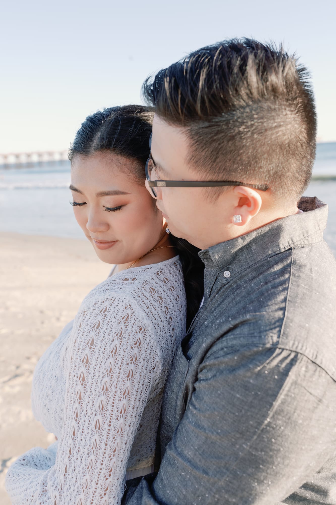 Thomas embracing Christine on the beach.